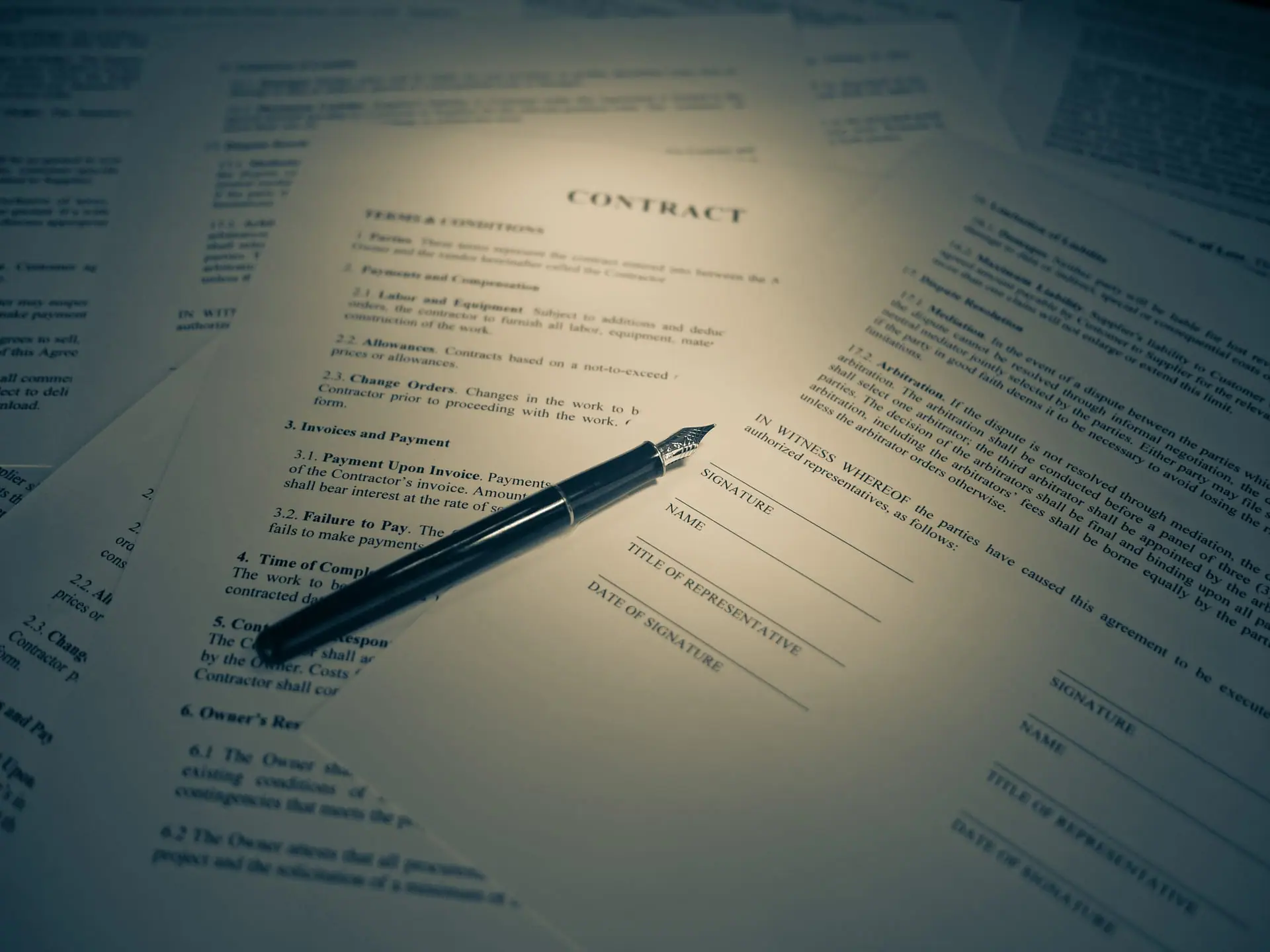 A legal contract document with a fountain pen, ready for signature