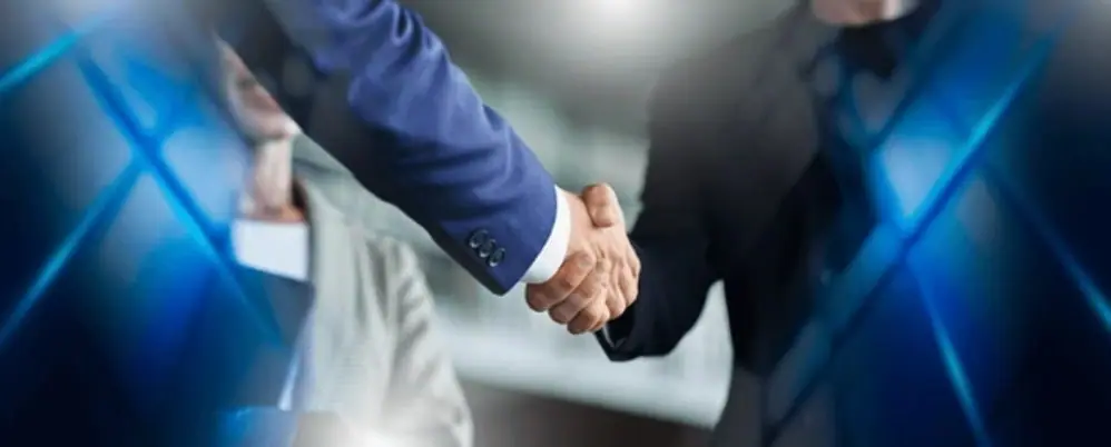 A handshake marking the handover of a completed asset